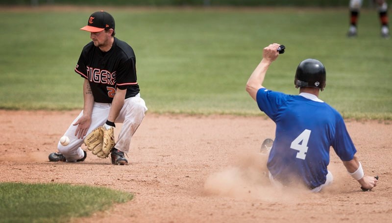 FIELDER – Nathan Forsburg of the St. Albert Tigers blocks an errant throw as Cody Jennings of the Blue Willow Angels slides into second base during Saturday&#8217;s game at