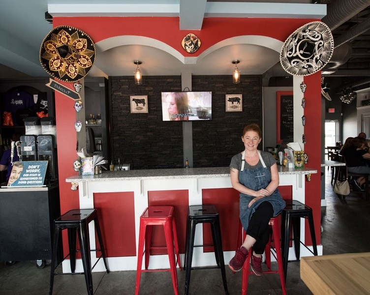 Owner-chef Jen Le sits at the bar of Cerdo Tacos and Tequila