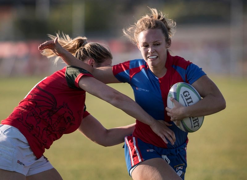 SARFC&#8217;s Mackenzie Doughty tries to elude the grasp of Strathcona Druids&#8217; Ainsley Fairbairn during Alberta women&#8217;s premier rugby action in St. Albert July 5