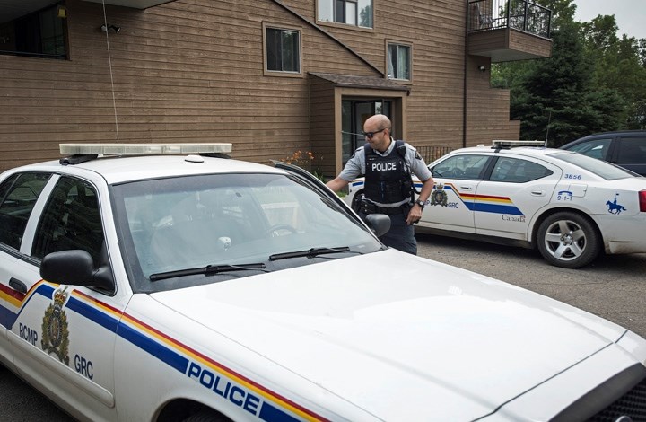 An RCMP constable leaves the apartment building at 75 Mission Ave. where Ronald Worsfold