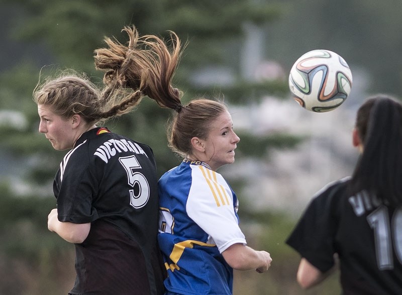 Hair flies as St. Albert Impact Premier&#8217;s Michelle Smith (R) battles for a loose ball with Victoria 2&#8217;s A. Ferguson during EDSA premier women&#8217;s soccer