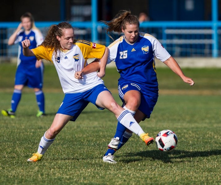 Impact/Inter FC (white) Isabelle Dobbin battles with Casey Paplawski (blue) Impact Premier. Paplawski scored her eighth goal of the season in the 3-0 win by Impact Premier