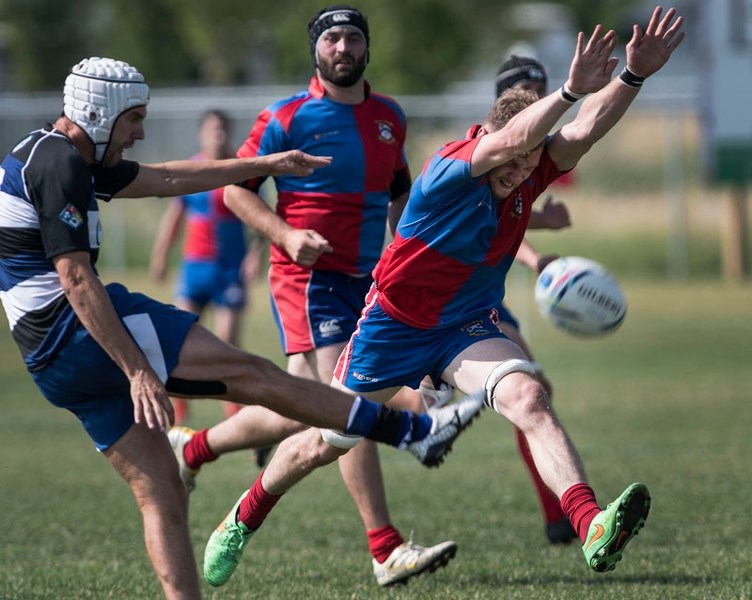 HANDS UP – Orrin Farries of St. Albert attempts to block a kick by Draco Broderick of the Calgary Rams in Alberta Cup premier men&#8217;s rugby action Saturday. The host team 