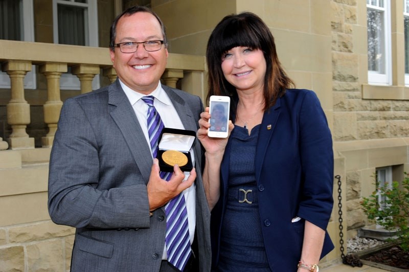 Chris Vilcsak accepted his daughter Emily&#8217;s Queen Elizabeth II Golden Jubilee Citizenship Medal for her during the ceremony on Tuesday. Emily FaceTimed in from Mexico
