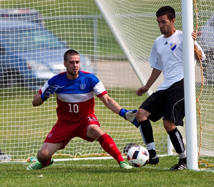 DEFENSIVE STAND – Adam King gets a foot on the ball in support of goalkeeper Louis Trupp for the St. Albert Men&#8217;s Soccer League all-stars against the St. Albert Impact