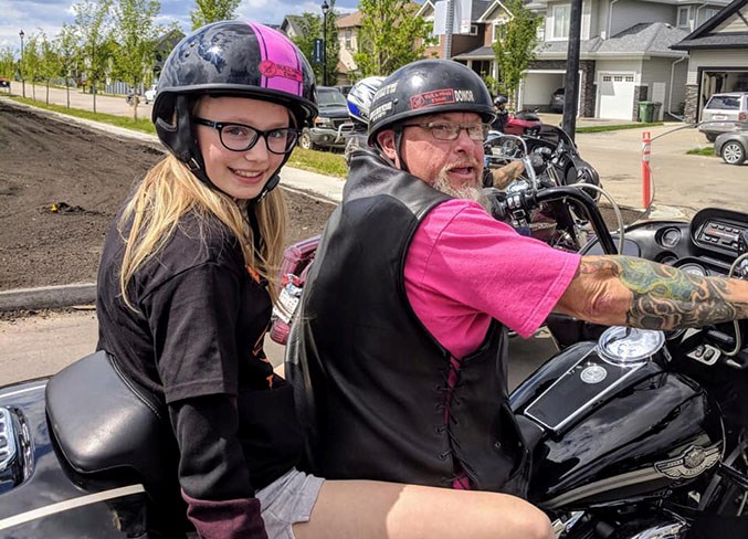 Another satisfied customer gets a free ride on the back of Steve Enns' Harley.