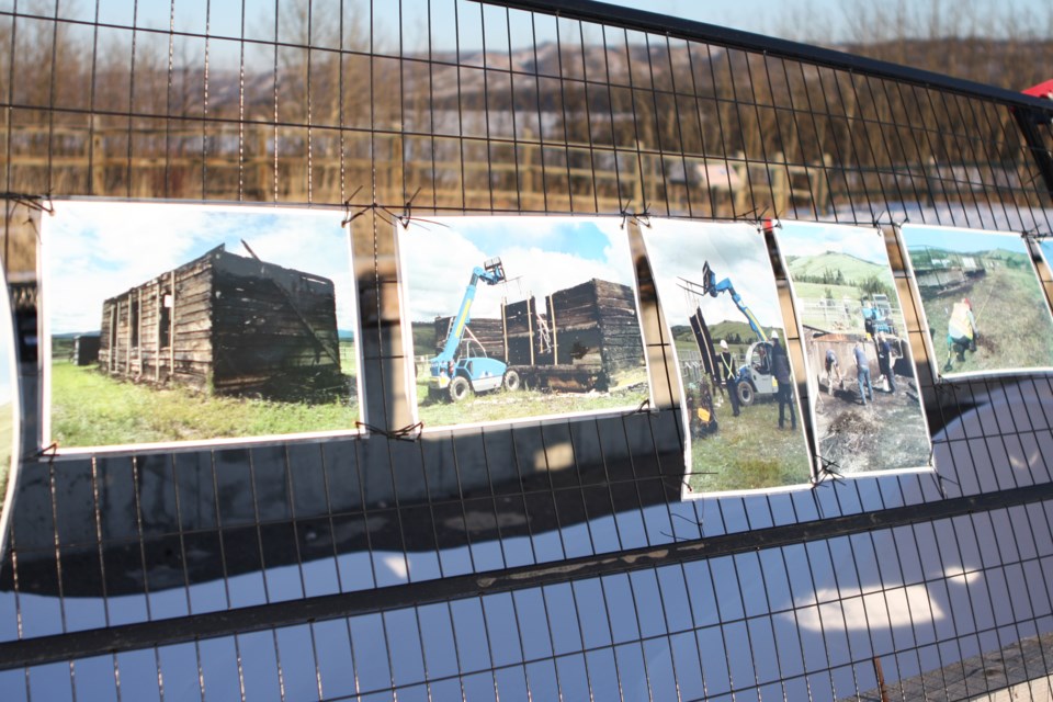 Pictures hung on the fence surrounding the ruins of the McDougall Memorial United Church as seen on Feb. 18, 2020, show reconstruction efforts underway. The historic church stood at the site overlooking Morley, Alta., for 142 years before it was destroyed by a suspicious fire in 2017. CLAIRE THEOBALD/Local Journalism Initiative