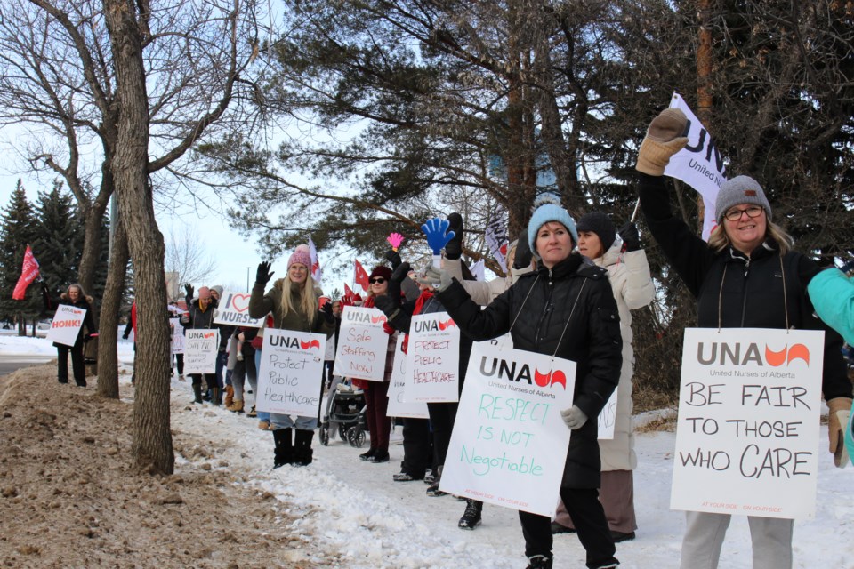 Nurses and supporters gather outside Sturgeon Community Hospital with various signs in support of the United Nurses of Alberta.