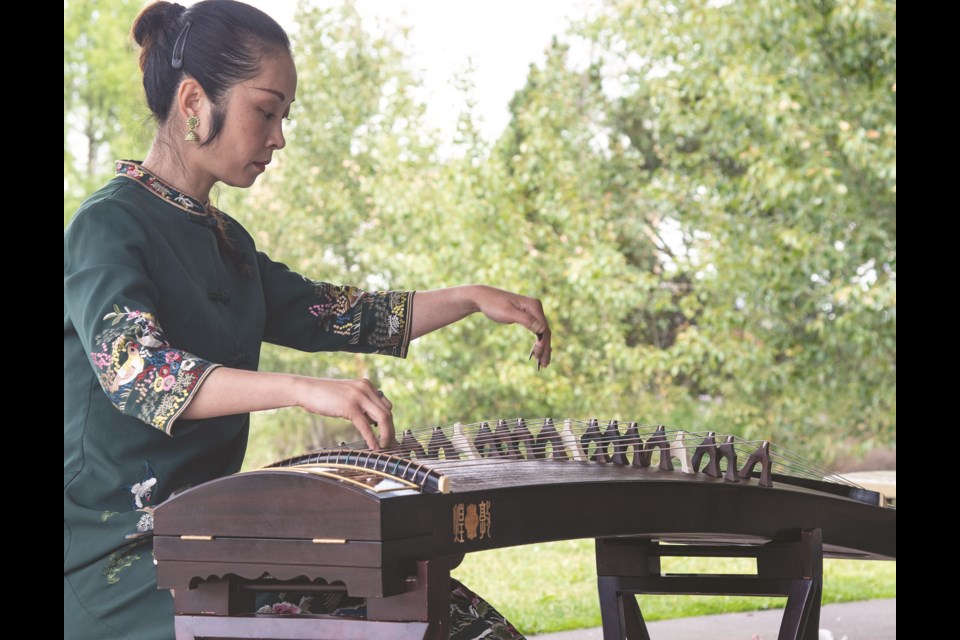 Wen Chi Ma plays the Guzheng at a Chinese Gathering  at Lions Park Aug. 4.
