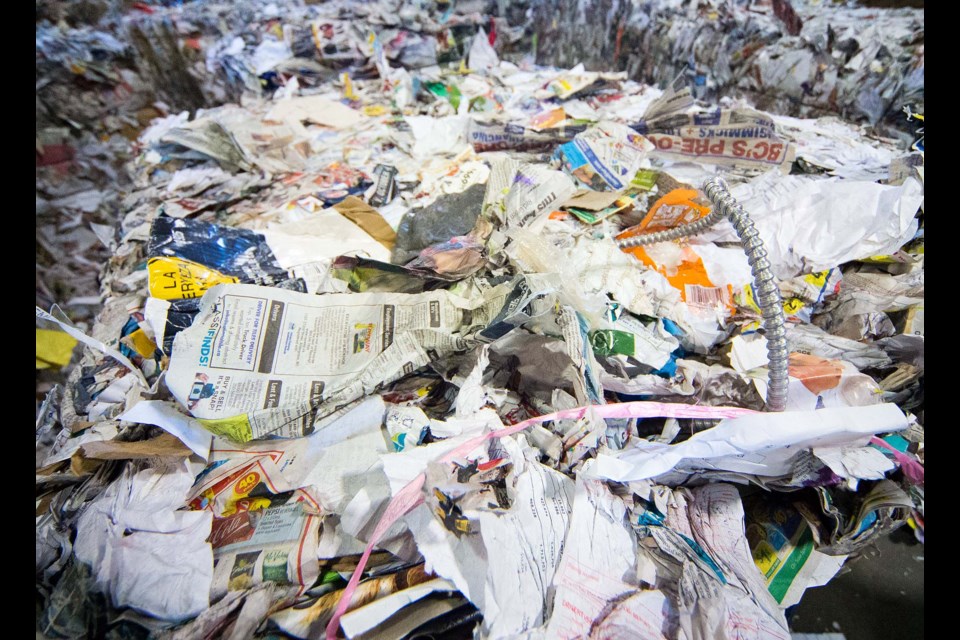 Although supervised depots generally have lower contamination rates than blue-bag collection, some problem items still slip through, such as this lamp cord in a load of paper. Such contaminants can cause entire shipments to be rejected.  CHRIS COLBOURNE/St. Albert Gazette