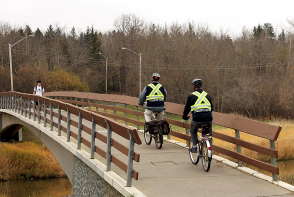 Two members of the St. Albert Citizen's Patrol Society riding bikes and patrolling the area. 