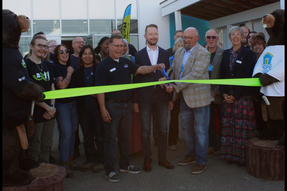 St. Albert city councillor Ken MacKay cutting the ribbon at the St. Albert ReStore on July 24. This was the official opening of Habitat for Humanity Edmonton's sixth ReStore. 