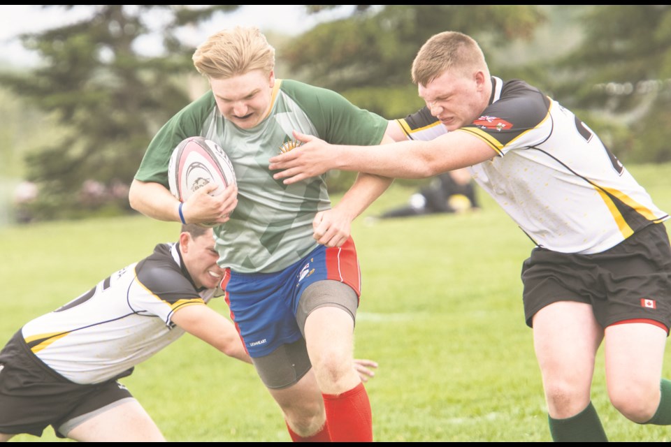  July 1, 2023  Cole Clymer breaks past two Manitoba players Stephen McGarvey (l) and Scott Gower(r) in  the Alberta Regional Championship XVs Rugby tournament in St. Albert. 
BRUCE EDWARDS/ St. Albert Gazette