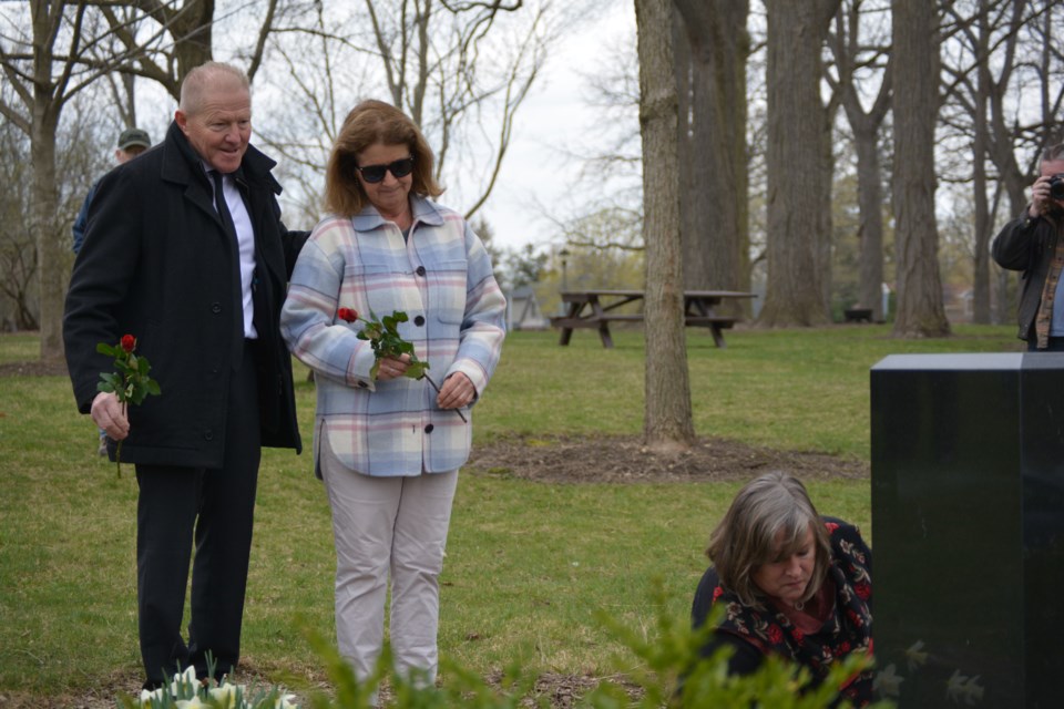 Mayor Martin Ritsma, Laura Ennett, and Patti-Jo Lindner laying their flowers at the Day of Mourning memorial.