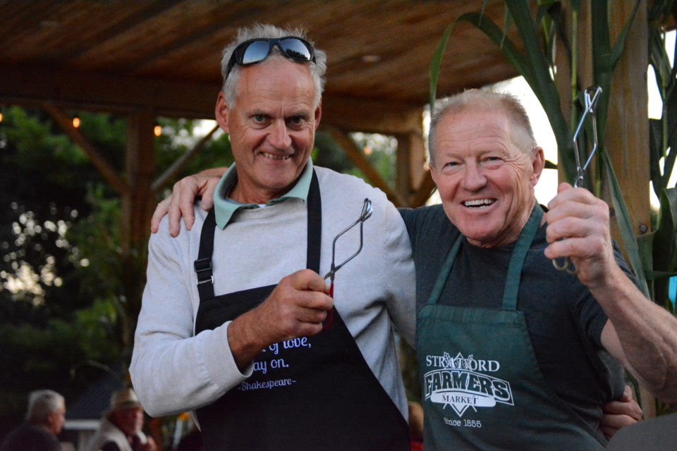 Piet Kamminga and Martin Ritsma pose in between customers at the 2nd annual Fiddles and Food Trucks event. Featuring Maggie's Wake on the stage, proceeds from the event at Ritsma's family farm go towards Stratford Summer Music. 