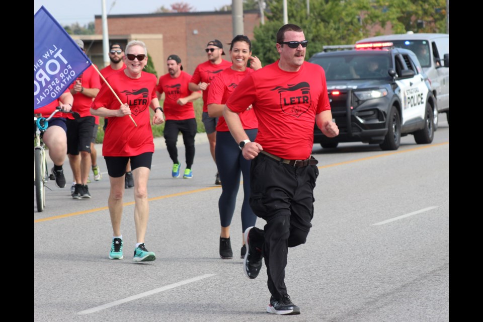 Jamie Koebel leads a group of runners at the Law Enforcement Torch Run on Wednesday in Stratford. 