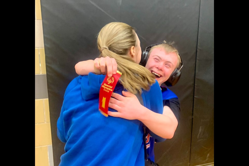 First place! Ben hugs his mom Michelle after his Stratford team won their third game of the tournament at Stratford District Secondary School and clinched first place in the Boucher Division. 