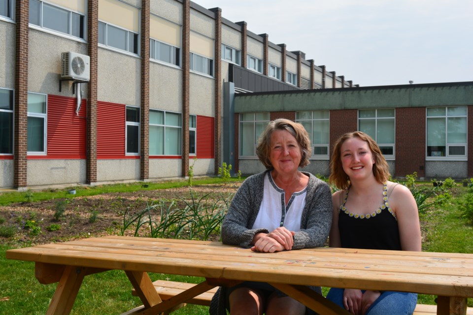 Christine Ritsma and her student Sammie Orr sitting next to the greenhouse at SDSS. Sammie Orr was one of this year's winners of the TD Community Leadership scholarship.