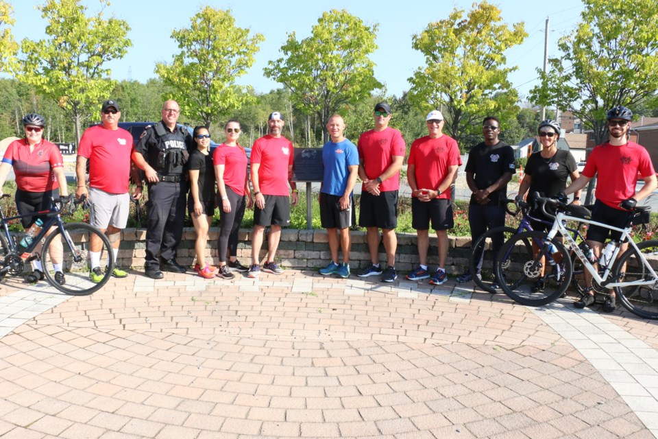 Greater Sudbury Police Service running team members and cyclists gathered at the Constable Joe MacDonald Memorial Park Monday before setting off on the tribute run. 
(Len Gillis / Sudbury.com)