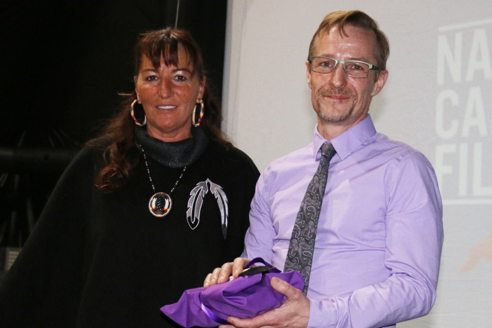 Canada Film Day was celebrated this week at Wahnapitae First Nation where Cultural Coordinator Tammy Chevrette, left, presented a welcoming gift to Axel Green, a representative of White Owl Studios which has created a huge soundstage structure at the reserve. 

(Len Gillis/Sudbury.com)