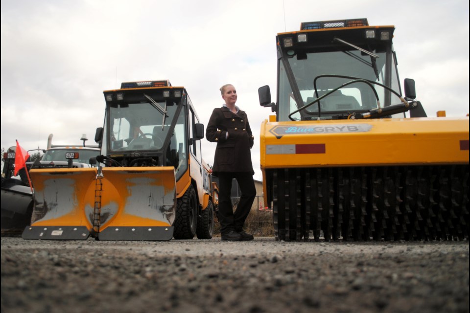 City of Greater Sudbury acting director of lineal infrastructure services Brittany Hallam is seen between two sidewalk plows during a media availability on Thursday to highlight the city’s snow-clearing efforts. The machine on the right has been fixed with a mechanical icebreaker at its front. (Tyler Clarke/Sudbury.com)                               