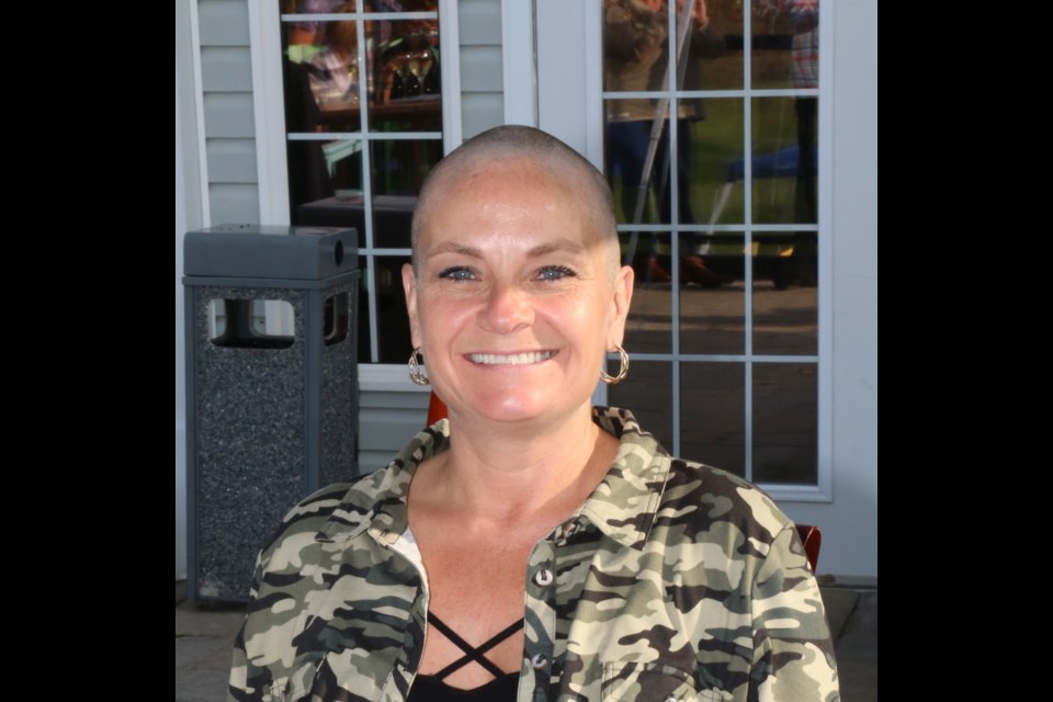 Karen Falldien Yawney of Sudbury raised thousands of dollars in support of childhood cancer victims when she got her head shaved Saturday.(Len Gillis / Sudbury.Com)