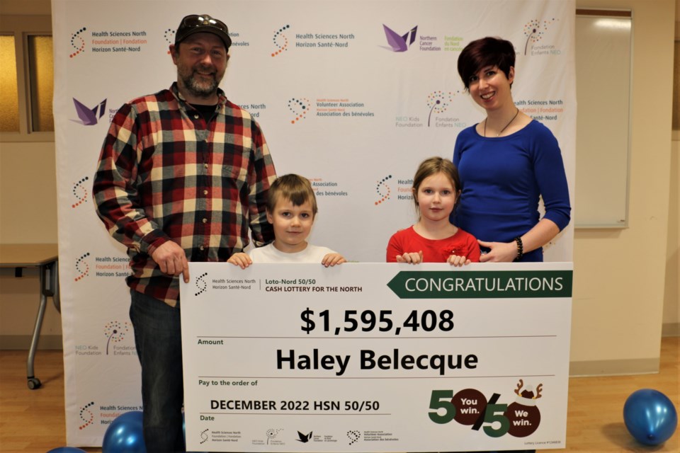 Smiling family members Michel Belecque, left, son Rowan Belecque, daughter Briar Belecque and Haley Belecque were on hand at Health Sciences North (HSN) Friday afternoon to pick up the winning jackpot of more than $1.5 million for the December 50/50 lottery draw.  (Len Gillis / Sudbury.Com)
