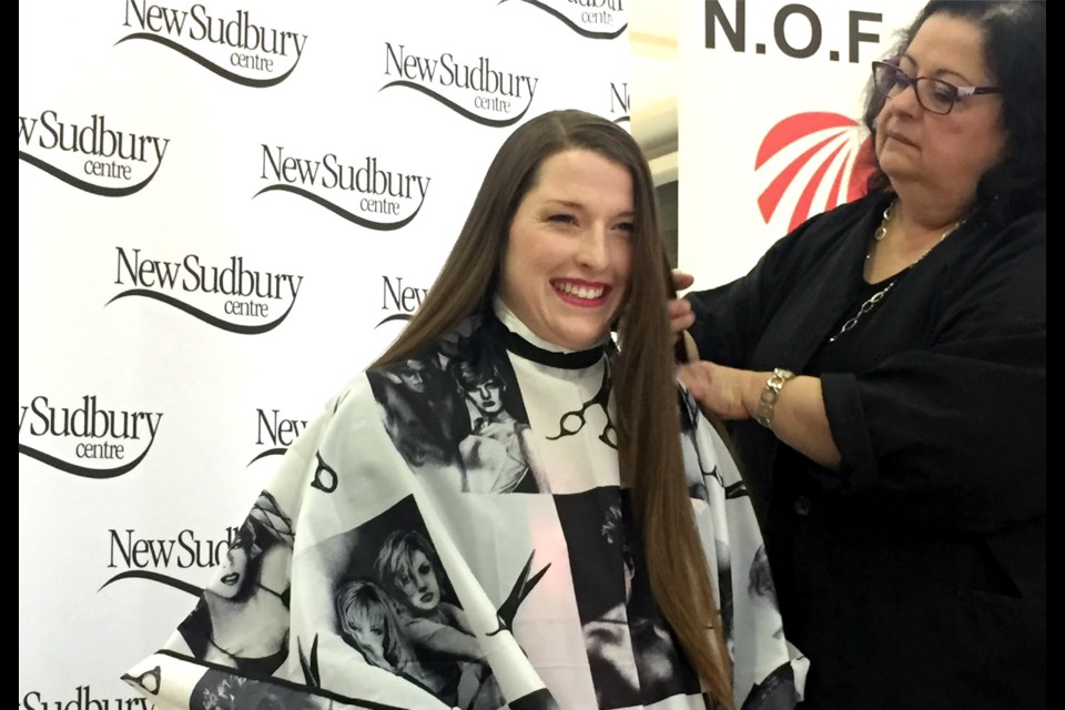 Larah Bingras is seen Saturday at the New Sudbury Centre getting her hair cut in support of Northern Ontario Families of Children With Cancer. Bingras raised more than $26,000 for the cause. (Darren MacDonald photos.)