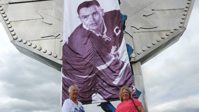 Lillian McCourt, George Armstrong's sister, and her daughter, Marilyn Kesek, pose next to his banner at the Big Nickel on Sunday. Darren MacDonald photo.
