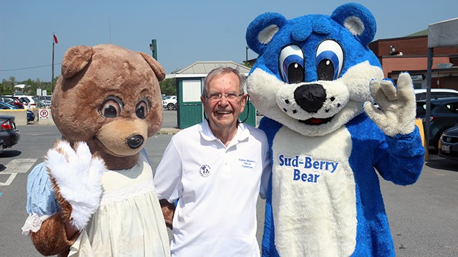 John Lindsay, chair of the Sudbury Blueberry Festival, stands between Sad-brina Bear (left) and Sud-berry Bear (right) at a press conference to kick off the 35th annual Blueberry Festival. (Keira Ferguson/ Sudbury.com)
