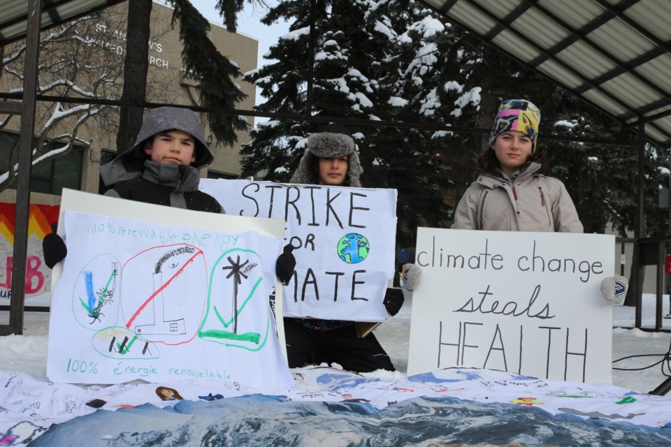 Sudbury students Arik, Sophia and Amber cut class Friday to raise concerns about Climate Change. (Allana McDougall/Sudbury.com)