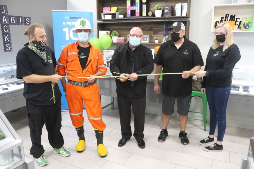 Mayor Brian Bigger and Cannabis Jacks owner John Shelegey cut the ribbon during the grand opening of the pot shop in Val Caron on Oct. 14.