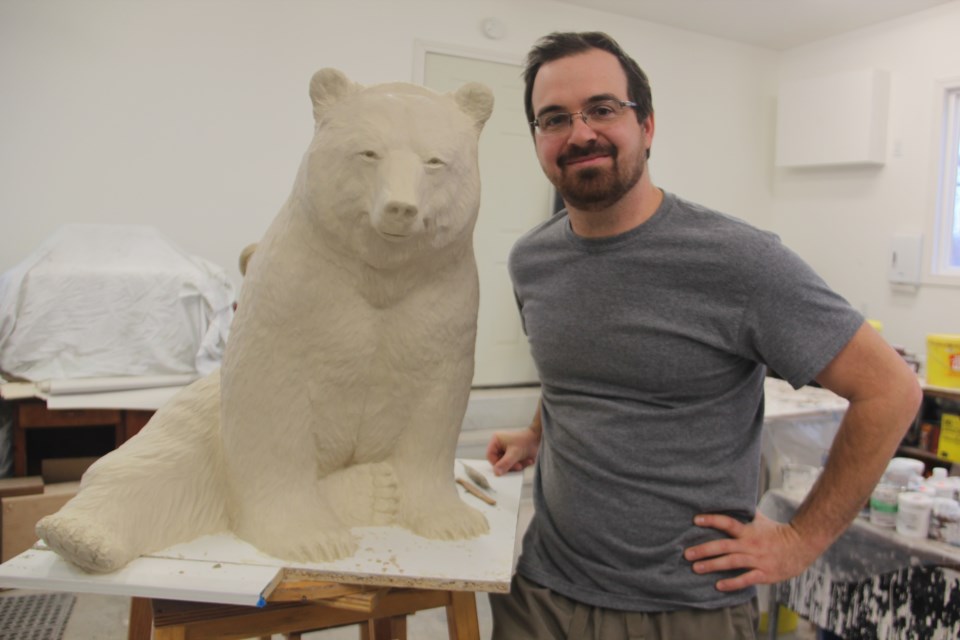 Tyler Fauvelle in his studio with a bear he's sculpting for an upcoming art show. (Heidi Ulrichsen/Sudbury.com)