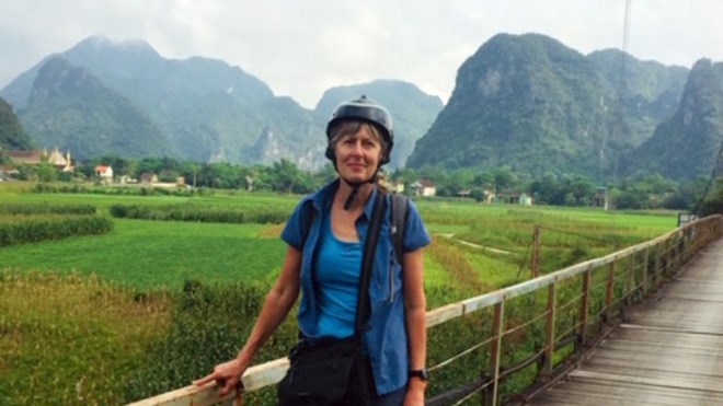 Suzanne Harvey sports a helmet as motorbike travel is quite common around Vietnam. In the background can be see the countryside around Phong Nha-Ke Bang. (Suzanne Harvey)