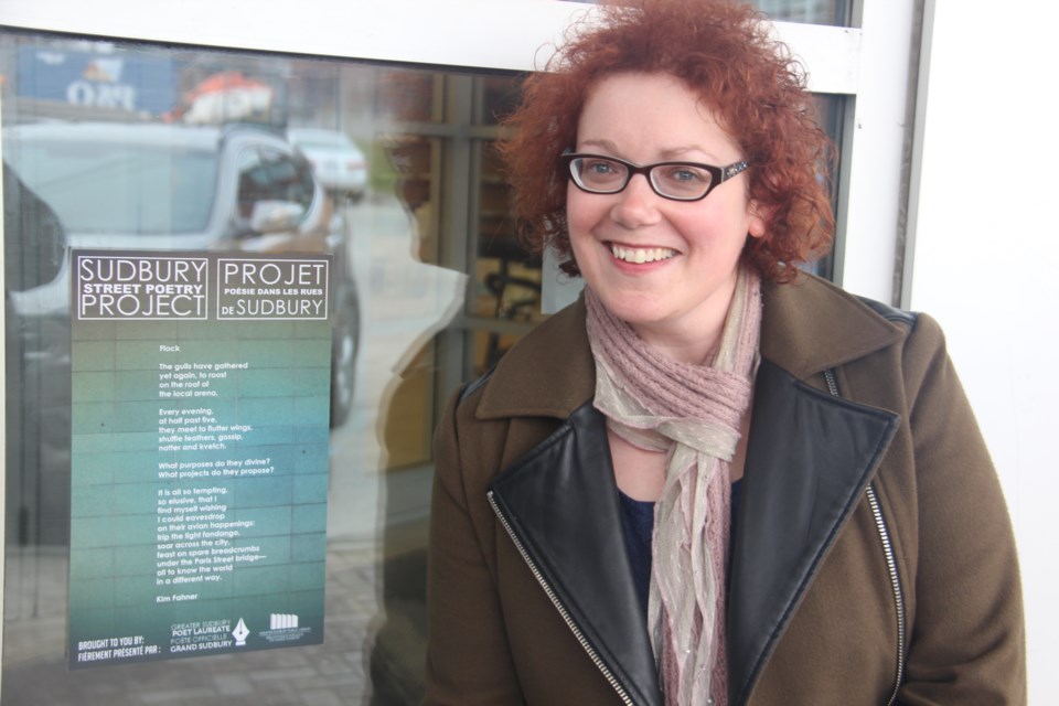 Greater Sudbury poet laureate Kim Fahner with her poem Flock at the main branch of the Greater Sudbury Public Library. Photo by Heidi Ulrichsen.