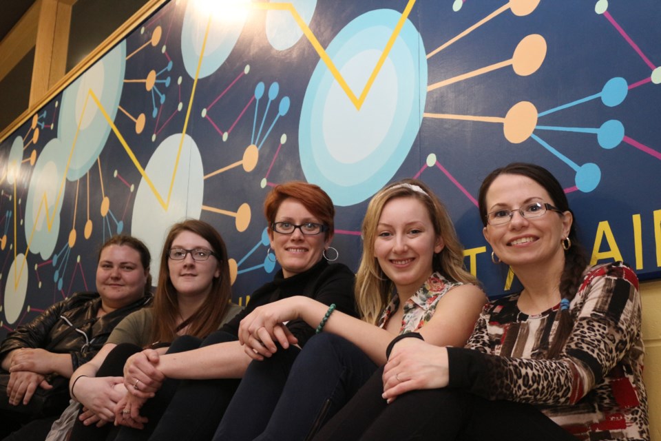 A group of students and alumni at Cambrian College's School of Creative Art and Design unveiled a large-scale mural at the greater Sudbury Airport April 28. Pictured left to right: Manon Roussel, Maggie Hobbs, Johanna Westby, Danielle Provencher and Darlene Benoit. Photo by Heather Green-Oliver.
