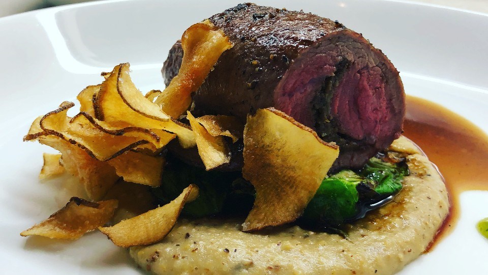 What's on the plate at The Cedar Nest? In this photo Chef Mark has prepared lamb sirloin stuffed with mushroom and olive duxelles, supported by mint gel, a popcorn polenta, accompanied by brussels sprouts and Sudbury harvested sunchoke chips. 