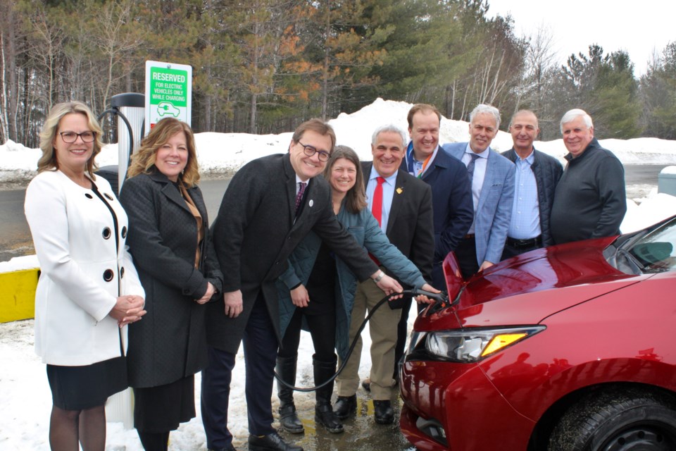 Dignitaries join electric vehicle owner Lynn Kabaroff, fourth from left, at one of Cambrian College’s 20 new charging ports. From left is Cambrian College VP of international, finance and admin, and applied research Kristine Morrissey, Sudbury Liberal MP Viviane Lapointe, Natural Resources Minister Jonathan Wilkinson, Kabaroff, Nickel Belt Liberal MPP Marc Serré, Mayor Paul Lefebvre, Cambrian College interim president Shawn Poland, Honeywell project manager Ali Ghaddar and Cambrian College facilities management senior manager Leo Vienneau. 