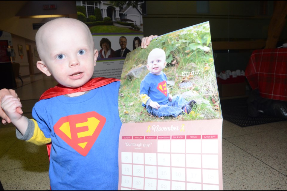 Emmit Barry looks over his photo in the Calendar of Hope. He's one of 11 faces featured in the new fundraising effort for the Breanna Baxter Fund. Photo by Arron Pickard.