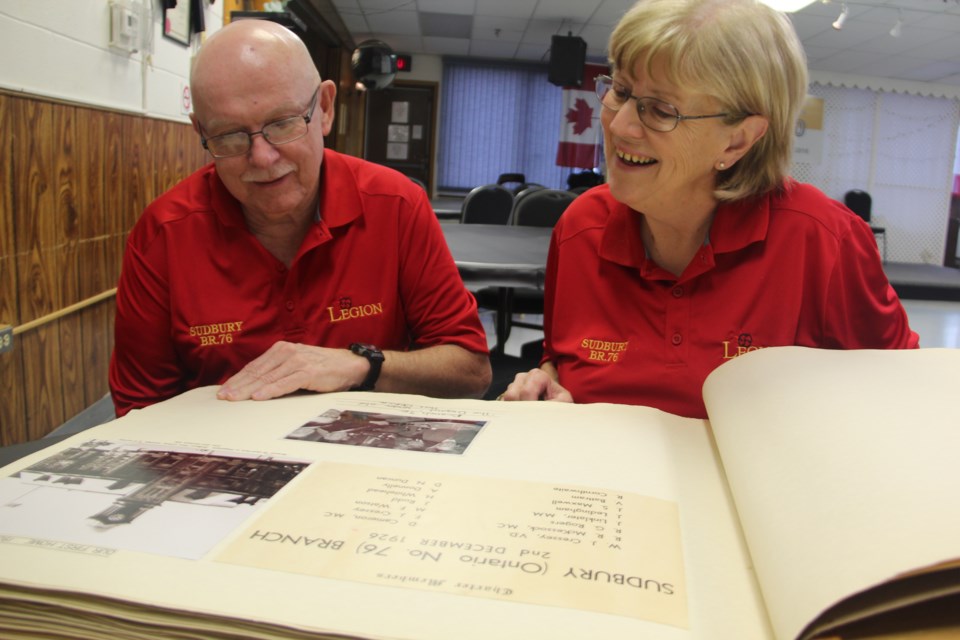 Royal Canadian Legion Dr. Fred Starr Branch 76 president Jim Young and public relations officer Gisele Pharand look over a scrapbook of branch history. The branch is celebrating its 90th anniversary. Photo by Heidi Ulrichsen.