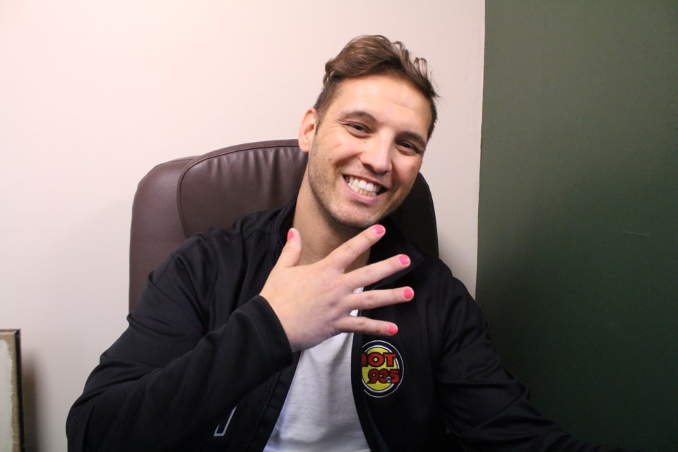 Hot 93.5's G-Rant shows off his pretty pink fingernails during the launch of the annual ManiCURES Campaign at the Serendipity Day Spa on Oct. 2. (Heather Green-Oliver/Sudbury.com)