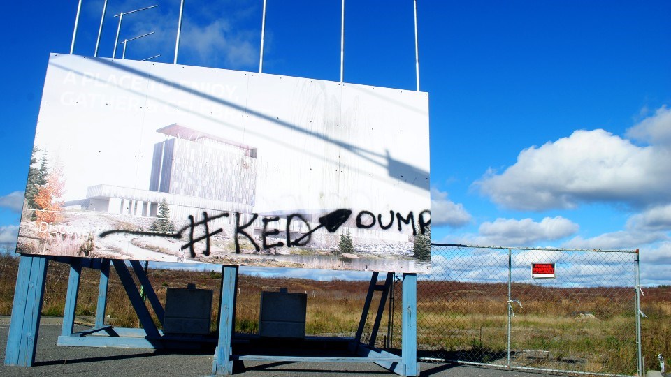 A sign at the Kingsway Entertainment District property is seen vandalized with a reminder of its proximity to the Sudbury Landfill Site.