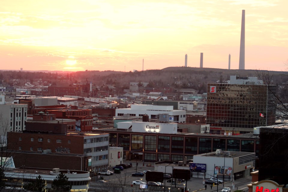 The sun is seen setting over Sudbury’s downtown core, where several office buildings are currently listed for sale.