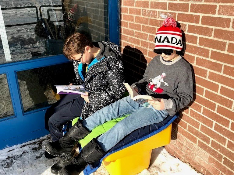 Chelmsford Public School students Malachi Peters, left, and Aedyn Lamothe-Moore, spend their nutrition break reading. (Supplied)

