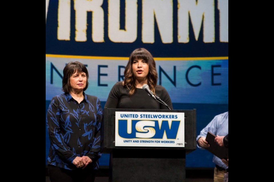 
Briana Fram speaks at a United Steelworkers conference as her mom Wendy Fram looks on. The mother and daughter were presented with the J. William Lloyd Award at the conference. (Supplied)