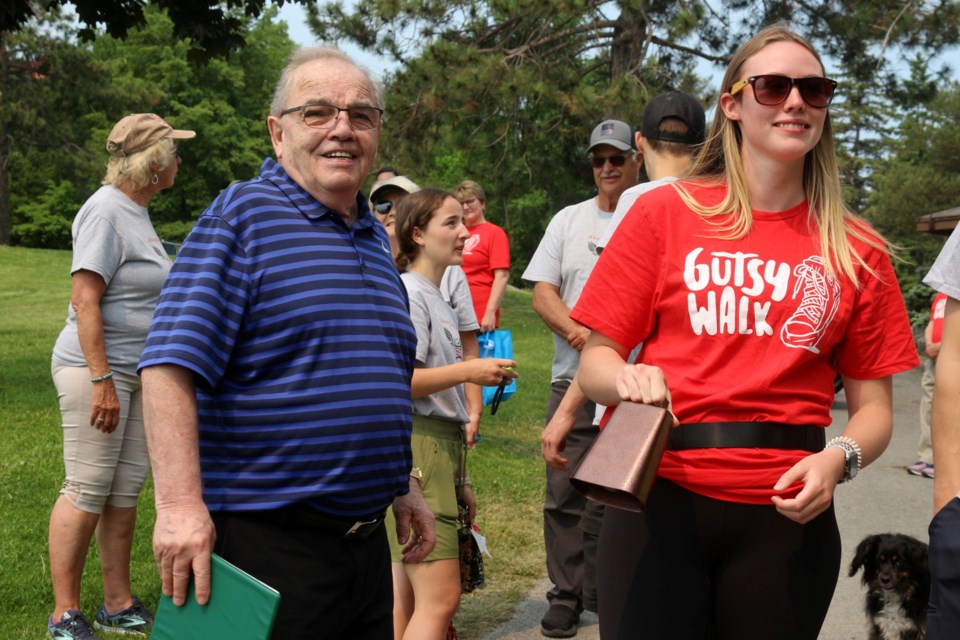 Avery Graham, the honourary chair of the 2023 Sudbury Gutsy Walk, rings the cowbell to start the walk as Deputy Mayor and Ward 8 Coun. Al Sizer looks on.