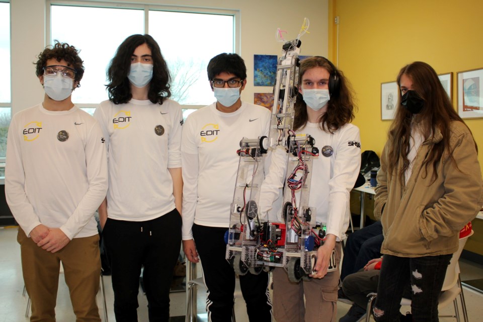 Members of the Lo-Ellen EDIT White team are seen here with their robot, who they’ve nicknamed “Marvin.” From left are David Langley, Ethan Kinnonen, Meer Shameer, Nathaniel Willock and Skyler Czaja.