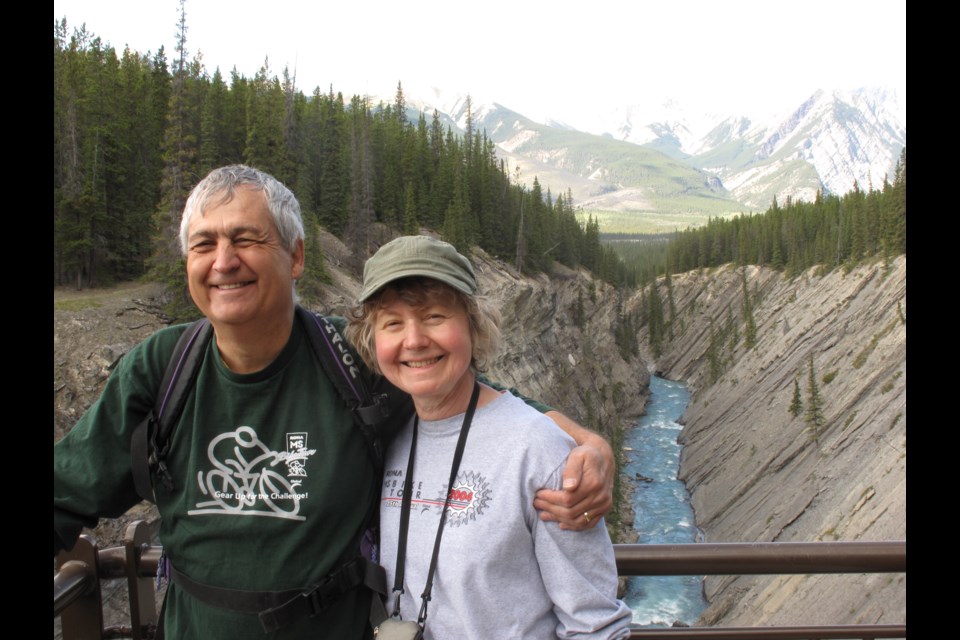 Cross-country cyclist Edmund Aunger, seen with his wife, Elizabeth Sovis, who was killed while cycling the Trans Canada Trail, pedals into town July 7 during his 12,500-km Ride the Trail for Elizabeth journey. Supplied photo.