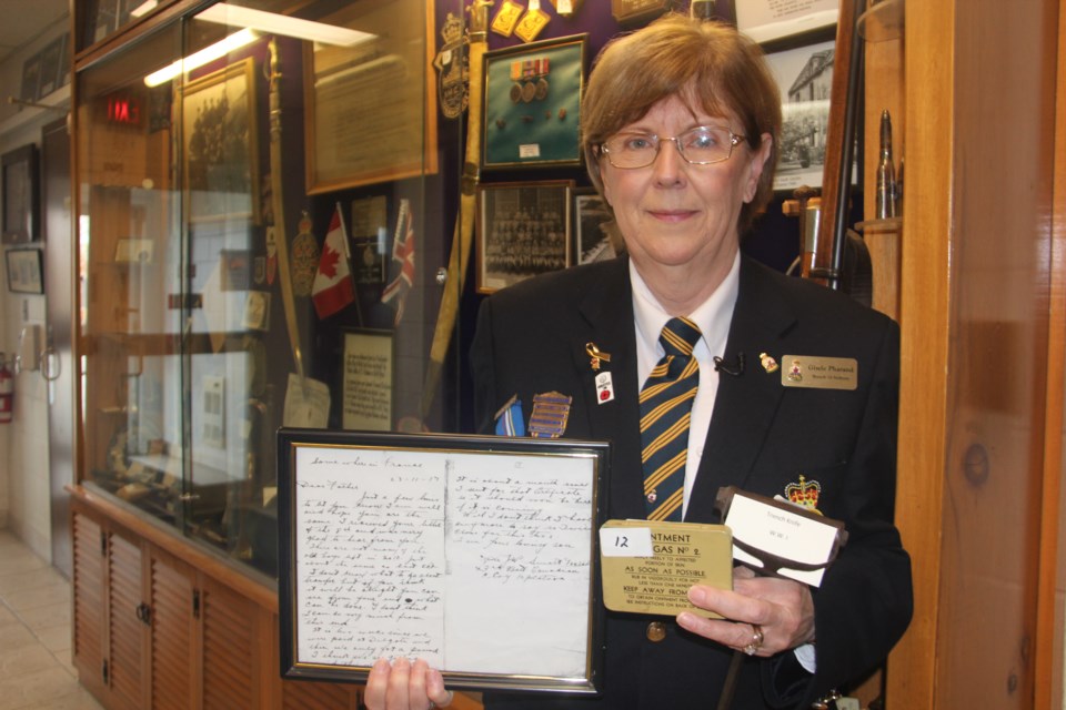  Gisele Pharand of Branch 76 of the Royal Canadian Legion shows off some of the First World War artifacts that are on display at the branch. This includes a letter from a soldier to his father, ointment for soldiers to apply after being gassed in the trenches and a trench knife, which helped them climb out of the trenches in an attack. (Heidi Ulrichsen/Sudbury.com)
