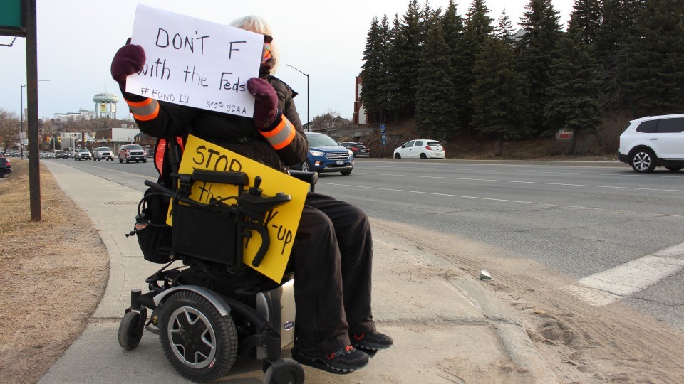 Clarissa Lassaline, an LU grad, parked her wheelchair at the corner of Paris Street and Van Horne waving signs in support of the university. 